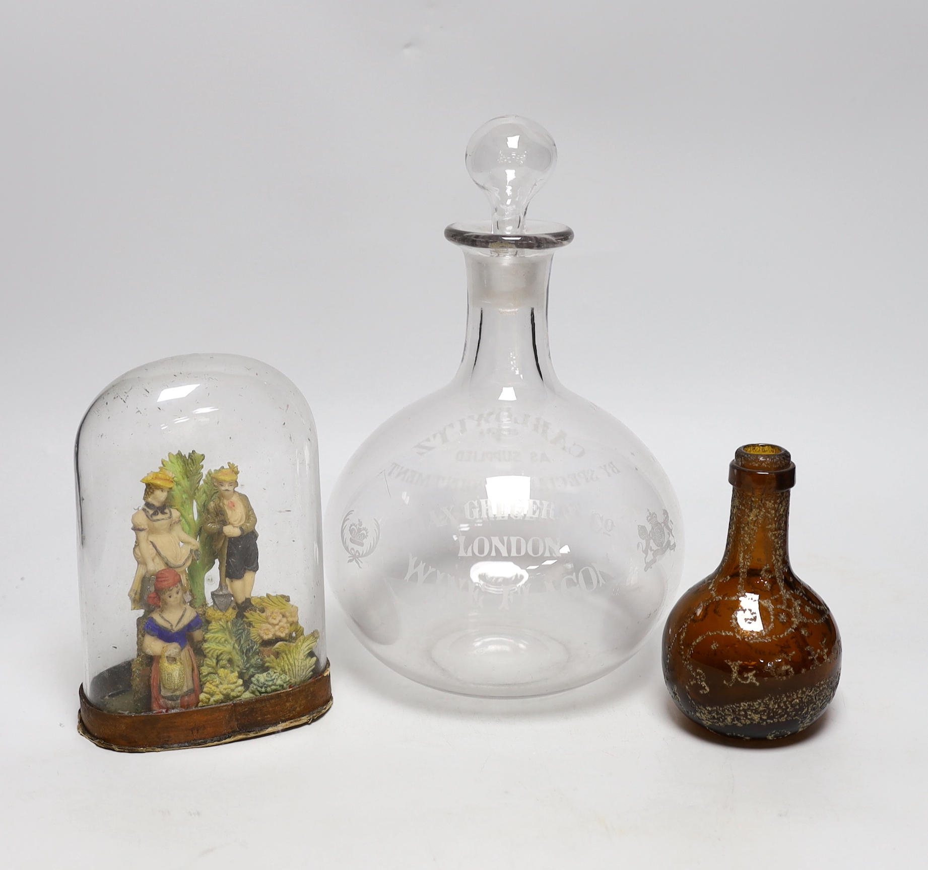 A large engraved, “Max Greger & Co London Wine Flagon”, a small amber glass bottle 1891 and a figural wax sculpture under dome, tallest flagon 26cm high
